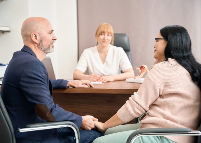Husband and wife visiting reproductologist at private medical clinic to make health check-up before planning baby, responsibility and reliability